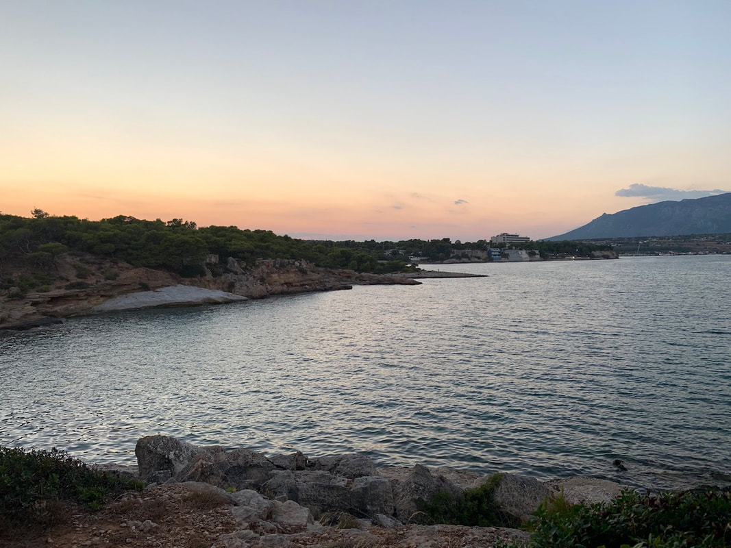 a small town just outside of Corinth in Greece with sunset view overlooking the sea